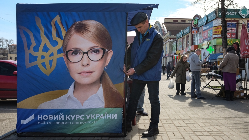 Before the first round ended, activists handed out flyers for Yulia Tymoshenko’s presidential campaign outside Dnipro’s central market [Maxim Edwards/Al Jazeera]