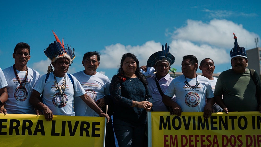 Joenia Wapichana, the first indigenous congresswoman in Brazil, poses with other members of the Wapichana tribe at the Free Land Camp in Brasilia [Mia Alberti/Al Jazeera] 