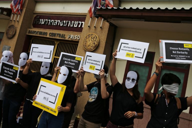 Demonstrators from Amnesty International hold placards outside the Bang Kwang Central Prison to protest against the death penalty in Bangkok, Thailand
