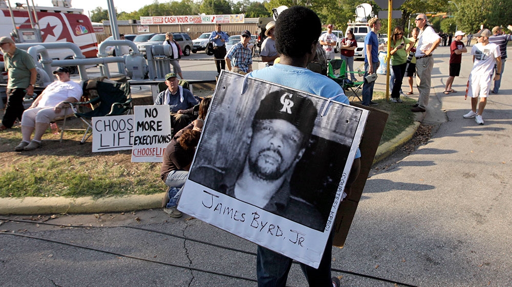 Ricky Jason wears a photograph of James Byrd Jr outside the Texas Department of Criminal Justice Huntsville Unit before the execution of Lawrence Russell Brewer [File: David J Phillip/AP Photo]