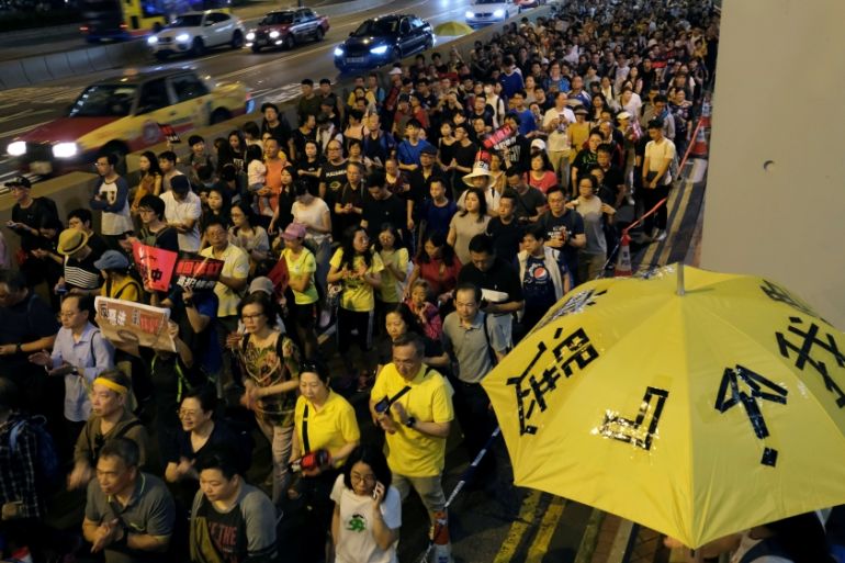 Demonstrators hold yellow umbrellas, the symbol of the Occupy Central movement during a protest to demand authorities scrap a proposed extradition bill with China, in Hong Kong