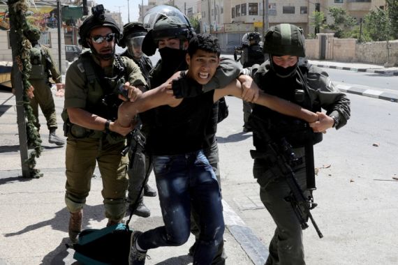 Israeli soldiers and border police detain a Palestinian during clashes in the West Bank town of Bethlehem