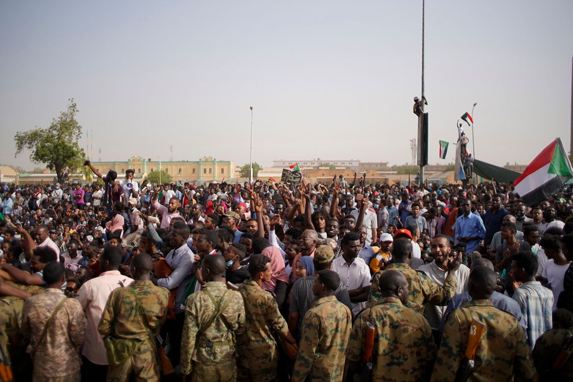Demonstrators take part in a protest demanding the departure of Sudanese President Omar al-Bashir as they wait for an announcement outside the Sudanese Army headquarters in Khartoum, Sudan, 11 April 2