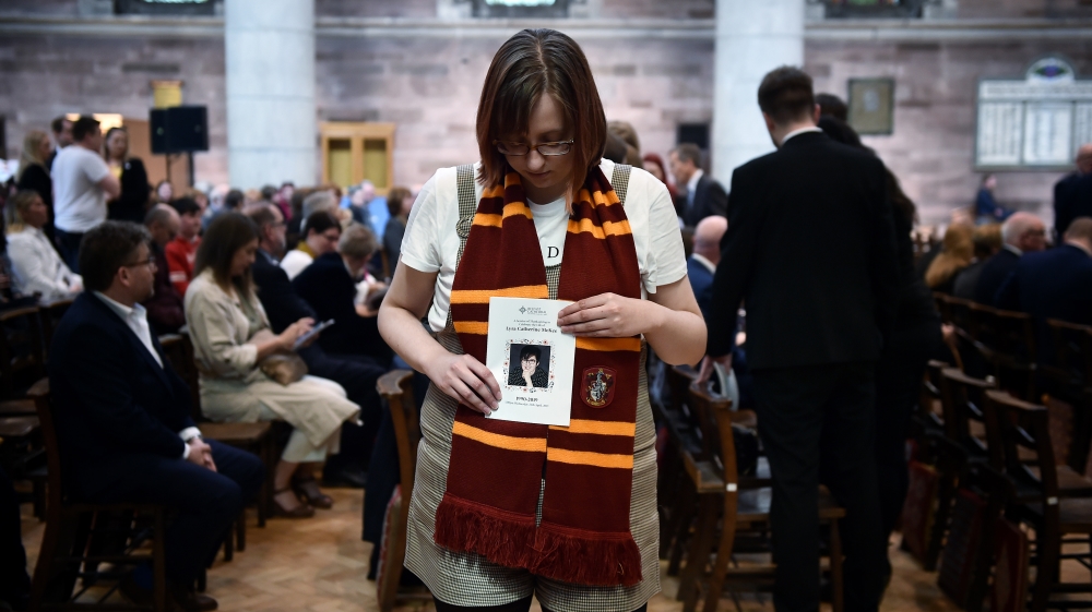 A friend of Lyra McKee holds an order of service as she attends her funeral at St. Anne's Cathedral in Belfast [Charles McQuillan/Getty Images]