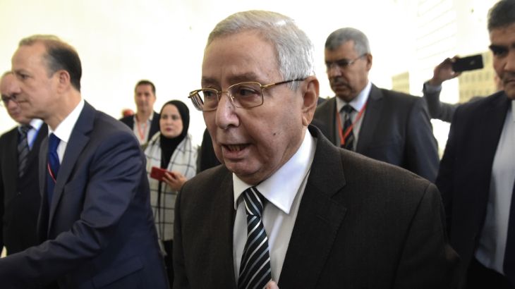 Abdelkader Bensalah (C) Algerian speaker of the upper house of parliament, arrives to attend a meeting at the Palais des Nations in the Algerian capital Algiers on April 9, 2019. Algerian lawmakers ar