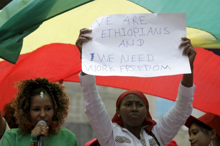 An Ethiopian migrant domestic worker holds up a placard during a parade in Beirut, to support the rights of migrant domestic workers in Lebanon and calling for a domestic workers union in Beirut