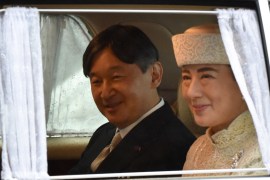 A vehicle carrying Crown Prince Naruhito (L) and Crown Princess Masako (R) leaves the Imperial Palace in Tokyo on April 30, 2019.