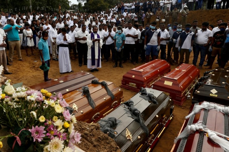 FILE PHOTO: People participate in a mass funeral in Negombo