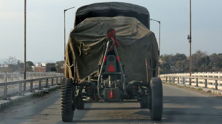 An Indian army artillery vehicle drives on a highway near Jammu