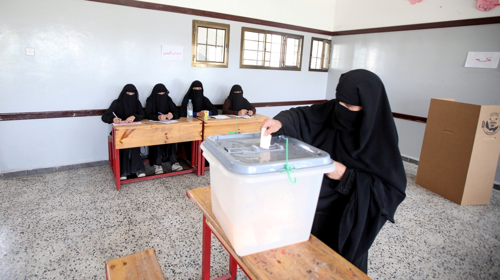 A woman casts her vote during a complementary parliamentary election in Sanaa on Saturday [Khaled Abdullah/Reuters]