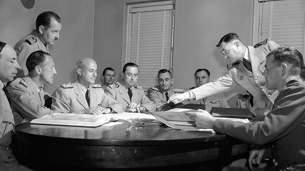 National liaison representatives to the then-SACLANT, NATO's Supreme Atlantic Command for the Atlantic, discuss the world situation and defence of the Atlantic in the event of war, at their weekly meeting in SACLANT headquarters, Norfolk, Virginia on September 30, 1954 [File: Bill Allen/AP Photo]
