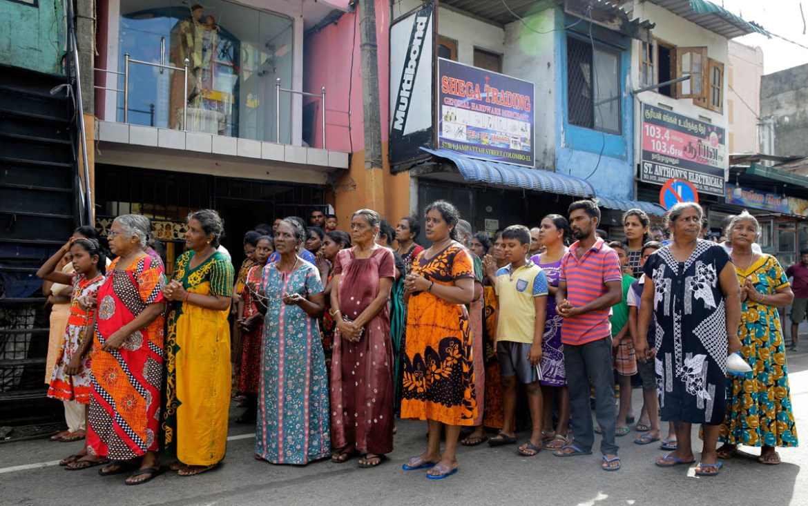 Sri Lankans pray during a three minute nationwide silence observe to pay homage to the victims of Easter Sunday''s blasts outside St. Anthony''s Shrine in Colombo, Sri Lanka, Tuesday, April 23, 2019. A