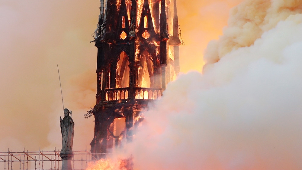Smoke billows as fire engulfed the spire of Notre Dame cathedral [Benoit Tessier/Reuters]