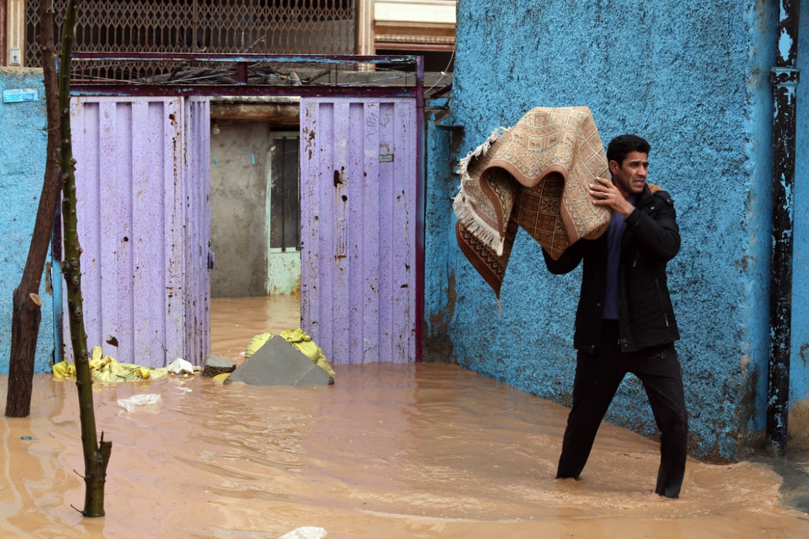 An Iranian man carries a carpet from his flooded home in the city of Khorramabad, Lorestan Province, western Iran, 01 April 2019 (issued 02 April 2019). At least 45 people have died in the past two we