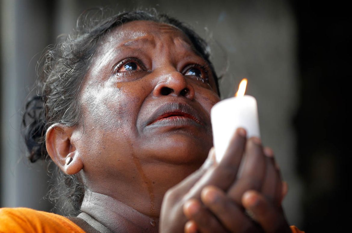 A Sri Lankan roman catholic woman prays during a three minute nationwide silence observe to pay homage to the victims of Easter Sunday''s blasts outside St. Anthony''s Shrine in Colombo, Sri Lanka, Tues