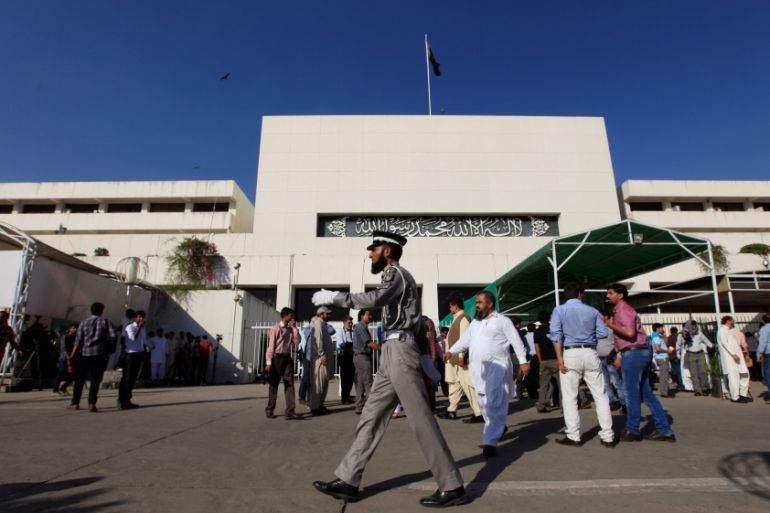 A traffic policeman walks in front of the parliament building during a session of the national assembly in Islamabad