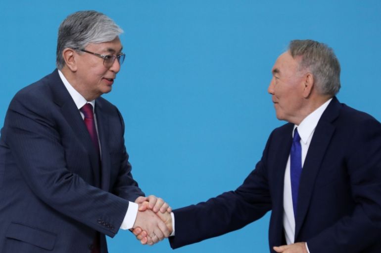 Kazakhstan''s President Tokayev shakes hands with former President Nazarbayev at a congress of the Nur Otan ruling party in Nur-Sultan