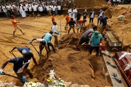 Coffins are laid in the ground during a mass burial for victims at a cemetery near St Sebastian''s Church in Negombo