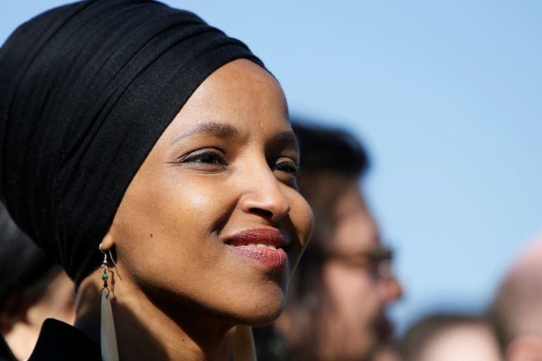 Rep. Omar smiles during at a news conference about Trump administration policies towards Muslim immigrants outside the U.S. Capitol in Washington