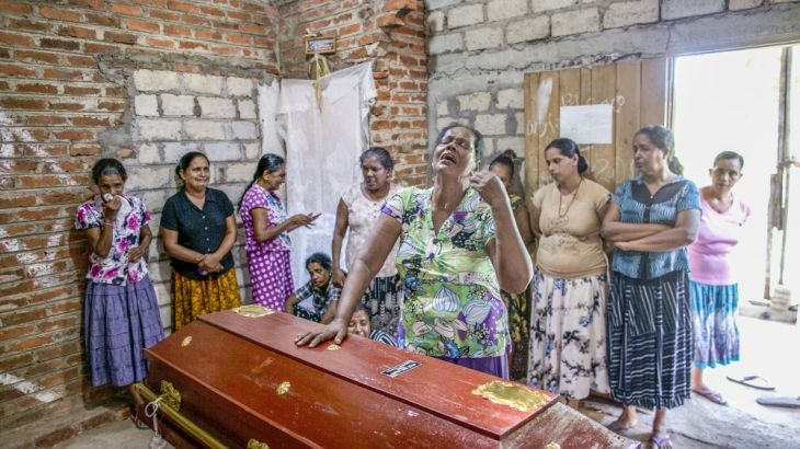 Lalitha, center, weeps standing beside the coffin with the remains of 12-year old niece, Sneha Savindi, who was a victim of Easter Sunday bombing at St. Sebastian Church, in Negombo, Sri Lanka, Monday