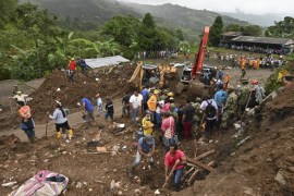 Rescue workers search for victims after a landslide in Rosas, Valle del Cauca department, in southwestern Colombia, on April 21, 2019. At least 14 people were killed and five others injured by a mudsl