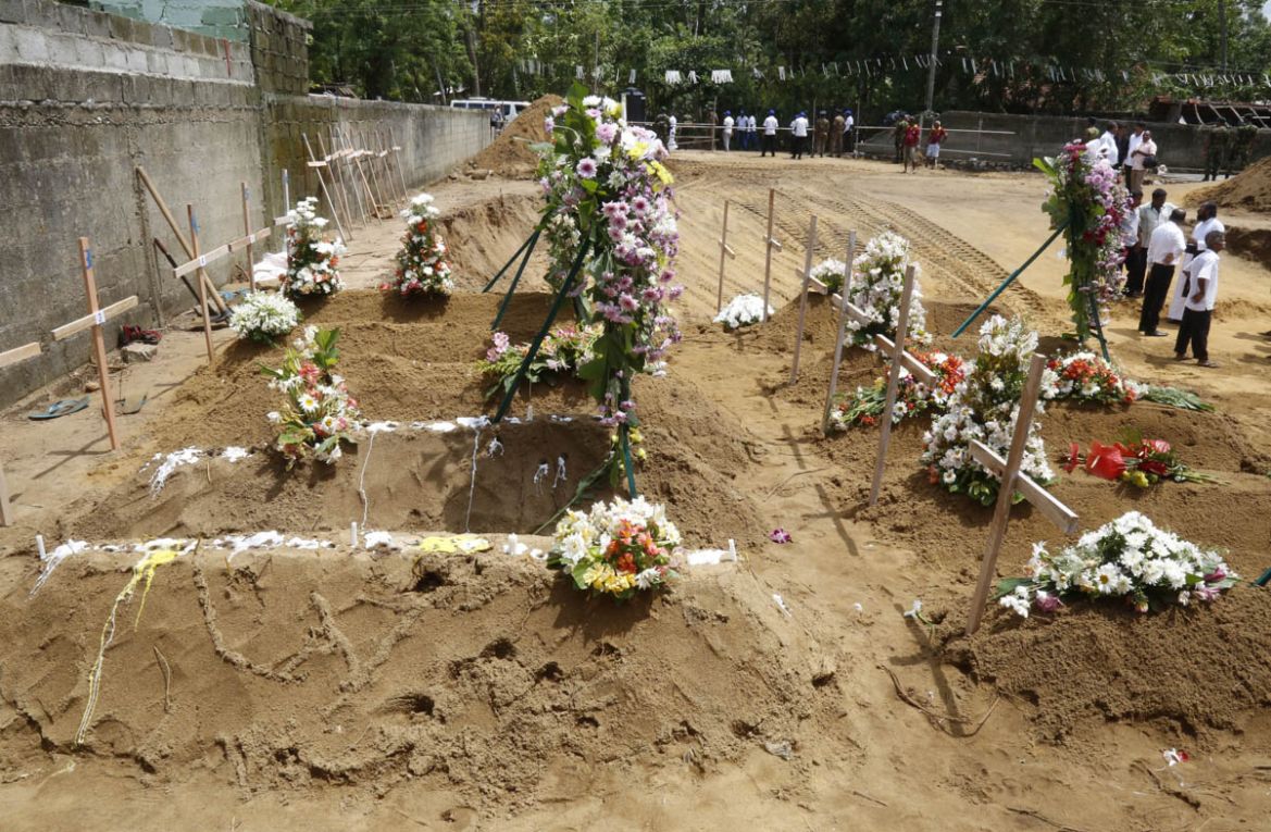 Coffins of the victims of a series of bomb blasts are buried at cemetery Don David Katuwapitiya during the mass funeral in Colombo, Sri Lanka, 23 April 2019. According to police, at least 290 people w