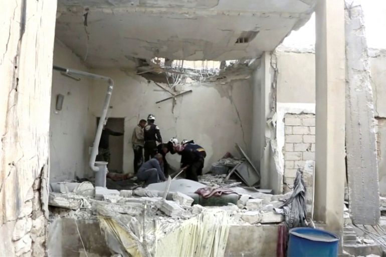 Still image shows civil defence forces digging through rubble after an air strike on location targeted by government forces, in Khan Sheikhoun, Idlib