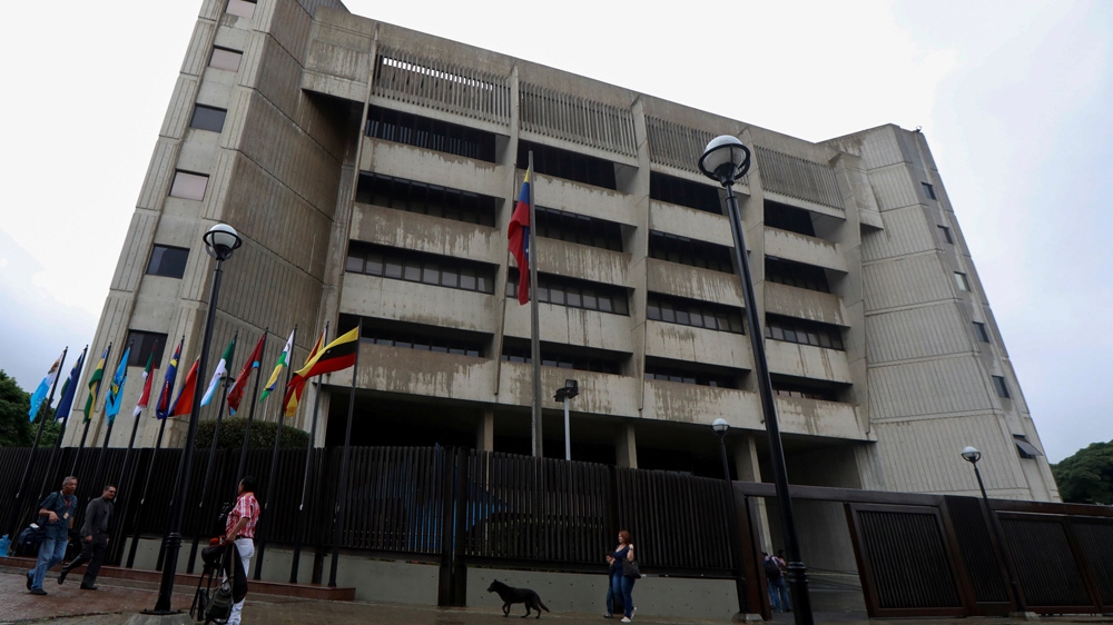 People walk in front of the building of Venezuela's Supreme Court of Justice (TSJ) in Caracas [File:Marco Bello/Reuters]