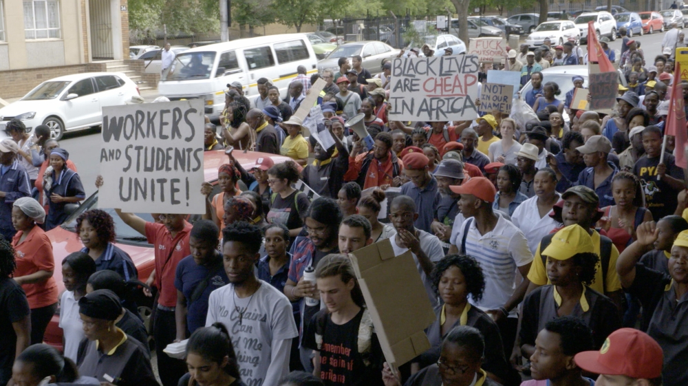 In 2015, students protest outsourcing employees at Wits University, a cost-cutting policy in which support staff hired through contracting companies were paid less and received fewer benefits [Al Jazeera]