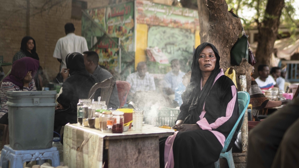 A woman sells tea in a cafe area close to the main gathering point for the demonstrations against the military government in Khartoum, Sudan on April 27, 2019 [Fredrik Lerneryd/Getty Images]