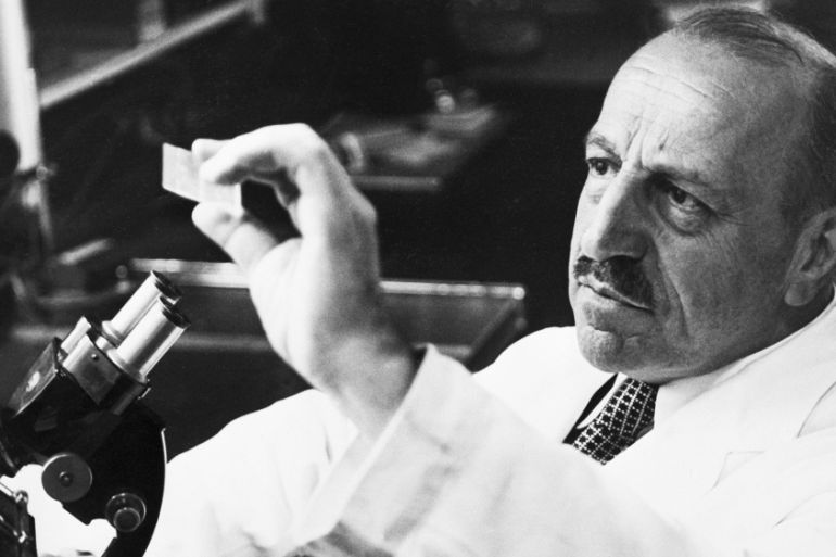 George Papanicolaou Examining a Slide (Original Caption) 5/13/1958-New York, NY: Dr. George N. Papanicolaou examines a slide here. "Dr. Pap" devised the "Pap" smear test for cancer, which the America