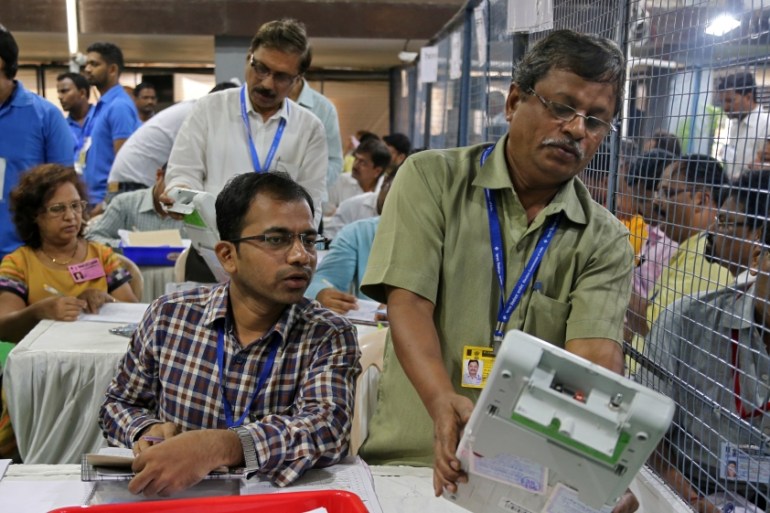 Election staff members count votes at a vote counting centre in Mumbai