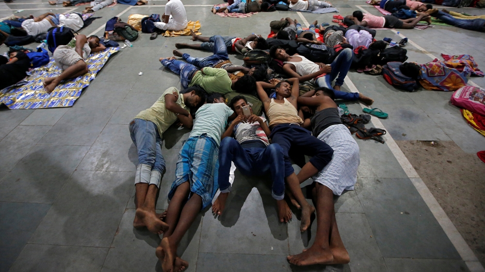 Stranded passengers rest at a railway station after trains between Kolkata and Odisha were cancelled in the wake of Cyclone Fani [Rupak De Chowdhuri/Reuters]