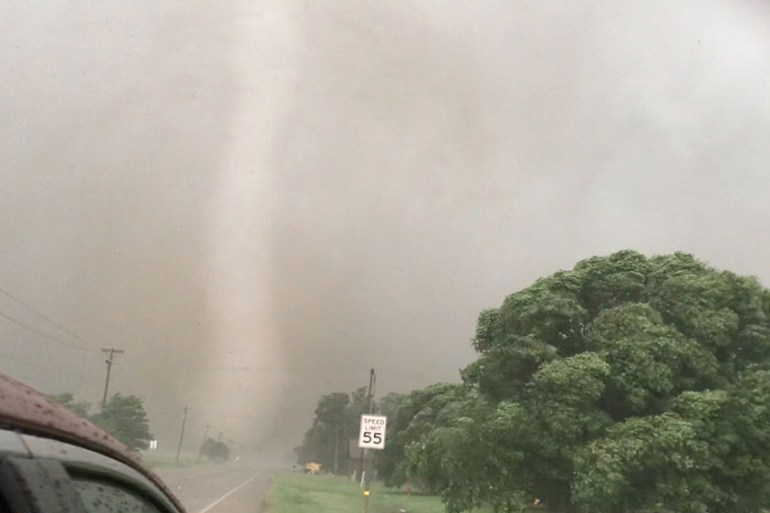 A tornado spins during stormy weather in Mangum, Oklahoma