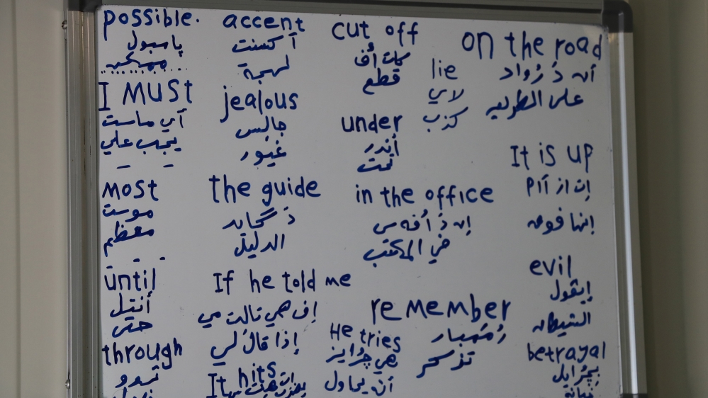 Every two weeks, Mustafa picks out a list of English words from Google to memorise. He writes them on his whiteboard [John Psaropoulos/Al Jazeera]