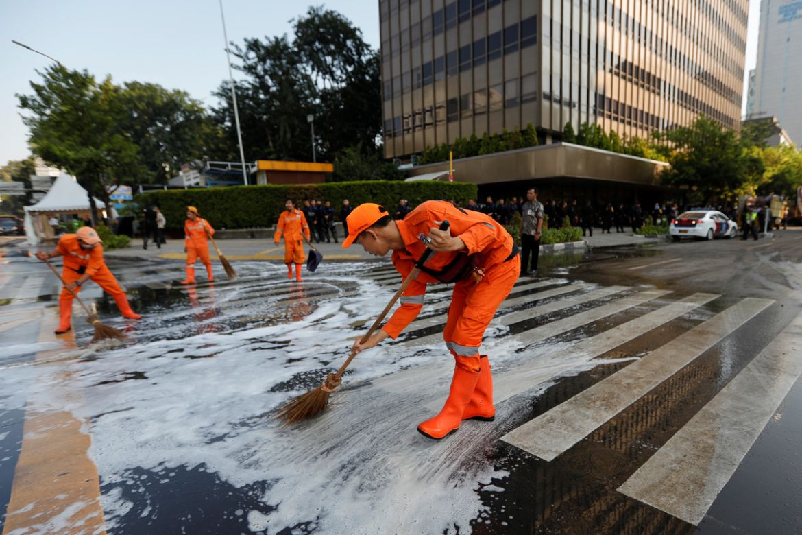 Workers clean the road after a riot outside Indonesia''s Election Supervisory Agency (Bawaslu) headquarters following the announcement of last month''s presidential election results in Jakarta, Indonesi