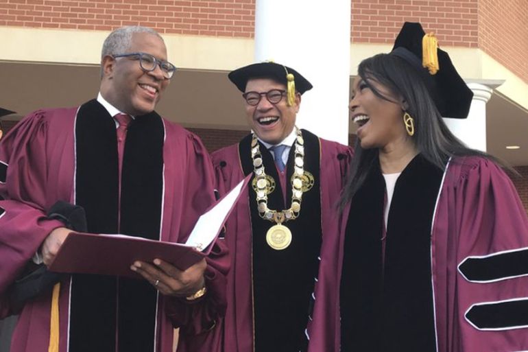 Robert F. Smith, left, laughs with David Thomas, center, and actress Angela Bassett at Morehouse College on Sunday, May 19, 2019, in Atlanta. Smith, a billionaire technology investor and philanthrop