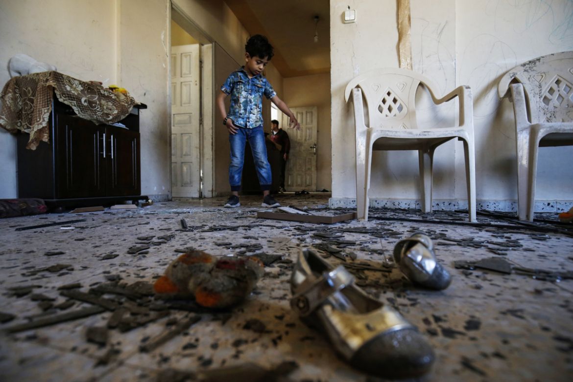 A Palestinian boy enters his family''s damaged apartment following Israeli air strikes on Rafah in the southern Gaza strip on May 5, 2019. Gaza militants fired fresh rocket barrages at Israel early tod