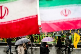 Iranian people carry umbrellas during a ceremony to mark the 40th anniversary of the Islamic Revolution in Tehran, Iran February 11, 2019