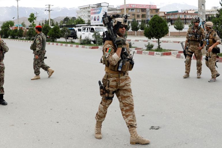 Afghan security forces keep watch at the site of a blast in Kabul, Afghanistan