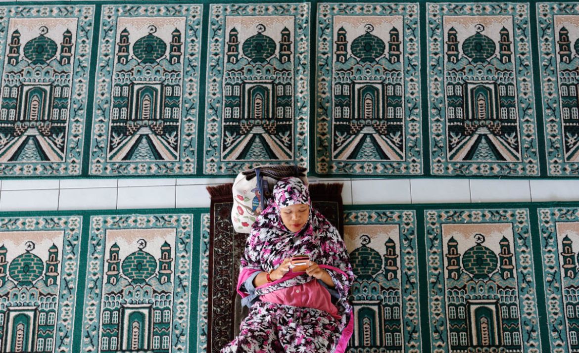 A woman rests at a mosque during the first day of the holy fasting month of Ramadan Monday, May 6, 2019, in Bali, Indonesia. Muslims around the world marked the start of Ramadan on Monday, a month of