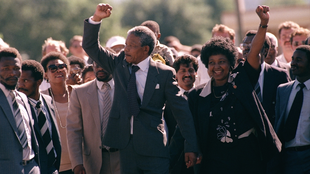 Nelson Mandela, walking with his wife, Winnie Madikizela-Mandela, was released in 1990 after serving 27 years in prison [File: AP Photo]