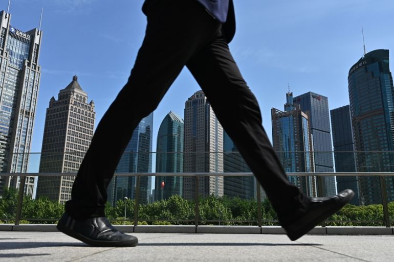 CHINA-US-TRADE-DIPLOMACY A man walks on a bridge in the financial district in Shanghai on May 7, 2019. Hope for an imminent resolution of the China-US trade dispute dimmed after US President Trump