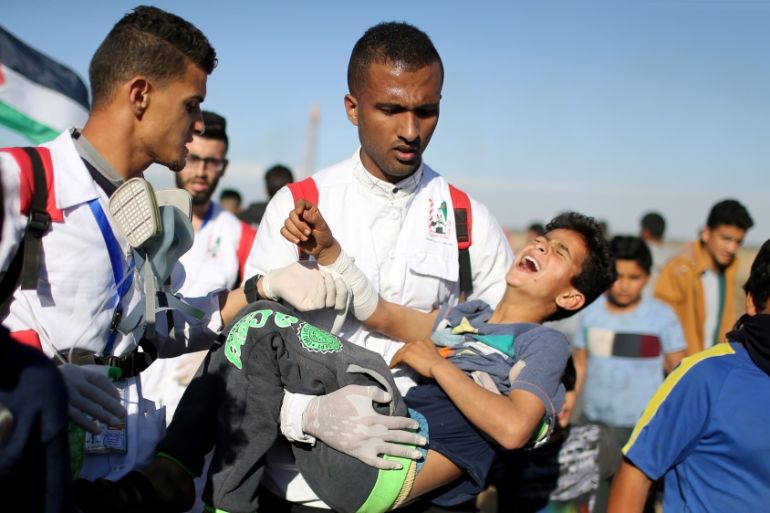 Wounded Palestinian boy is evacuated during a protest at the Israel-Gaza fence in the southern Gaza Strip