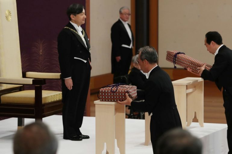 Japan''s Emperor Naruhito stands as Imperial Household Agency officials carry two of the so-called Three Sacred Treasures of Japan, during a ritual called Kenji-to-Shokei-no-gi, a ceremony for inheriti