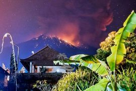 Thick smoke and glow from lava are seen as Mount Agung volcano erupts in Karangasem Regency, Bali, Indonesia