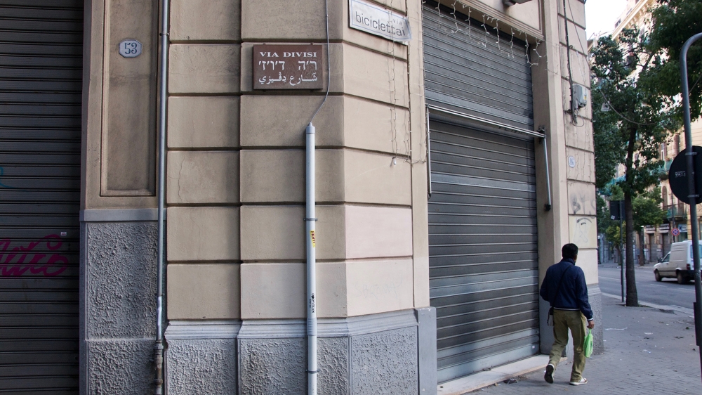 The Via Divisi street sign, like all major street signs in the historic centre of Palermo, is written in Italian, Hebrew and Arabic [Savin Mattozzi/Al Jazeera]
