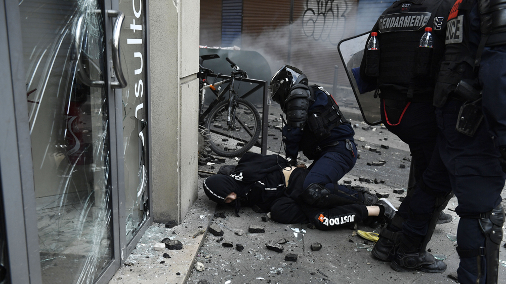 Police arrest a protester during the Labour Day demonstration in Paris on Wednesday [Julien de Rosa/EPA-EFE]