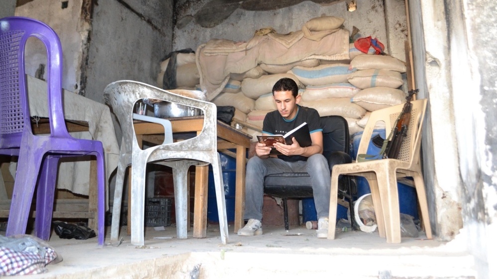 The young men saved roughly 15,000 books from the rubble of war-torn Daraya [Al Jazeera]