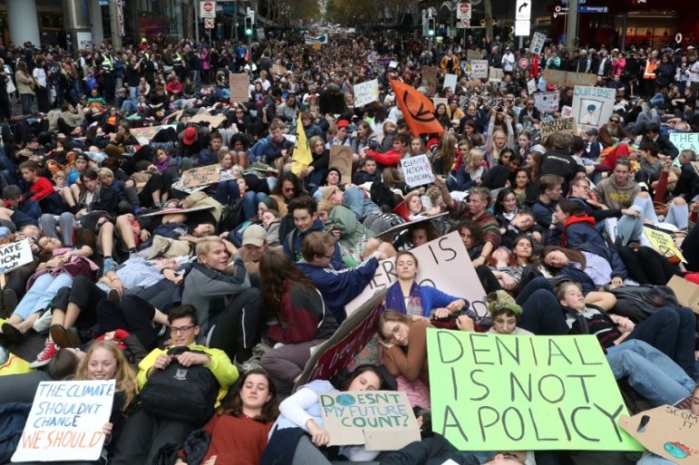 Protesters lie down along Swanston Street during a "Climate Rally"